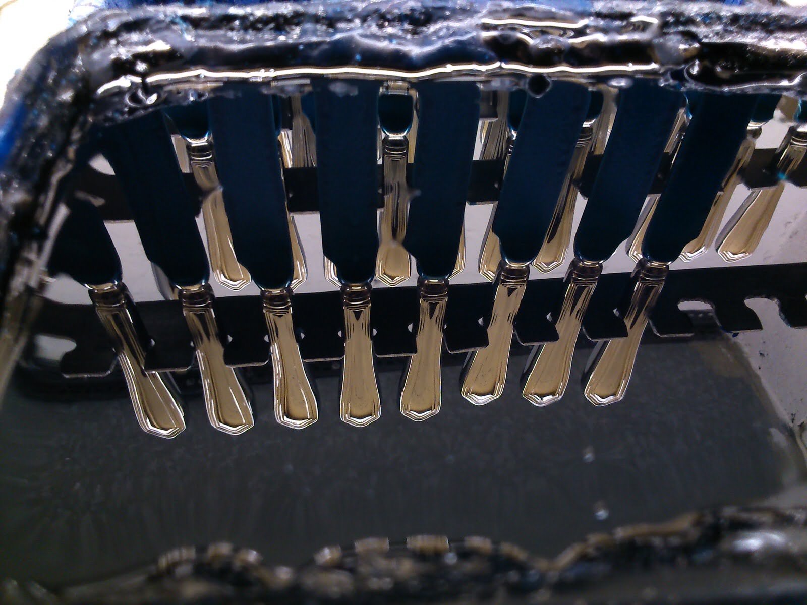Silver-plated cutlery handles drying after plating